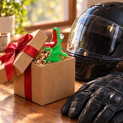 Lizard buddy in a gift box next to a motorcycle helmet and gloves